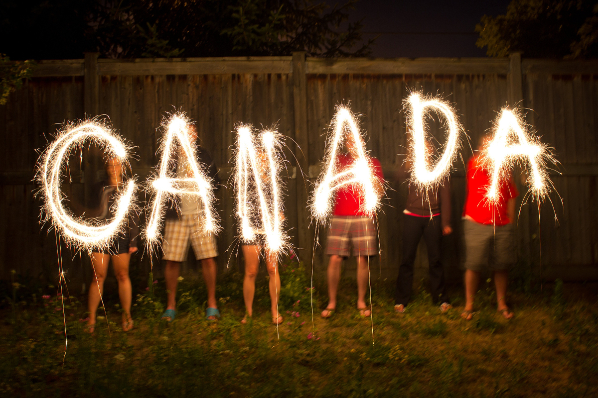 Group of children celebrating Canada with fireworks